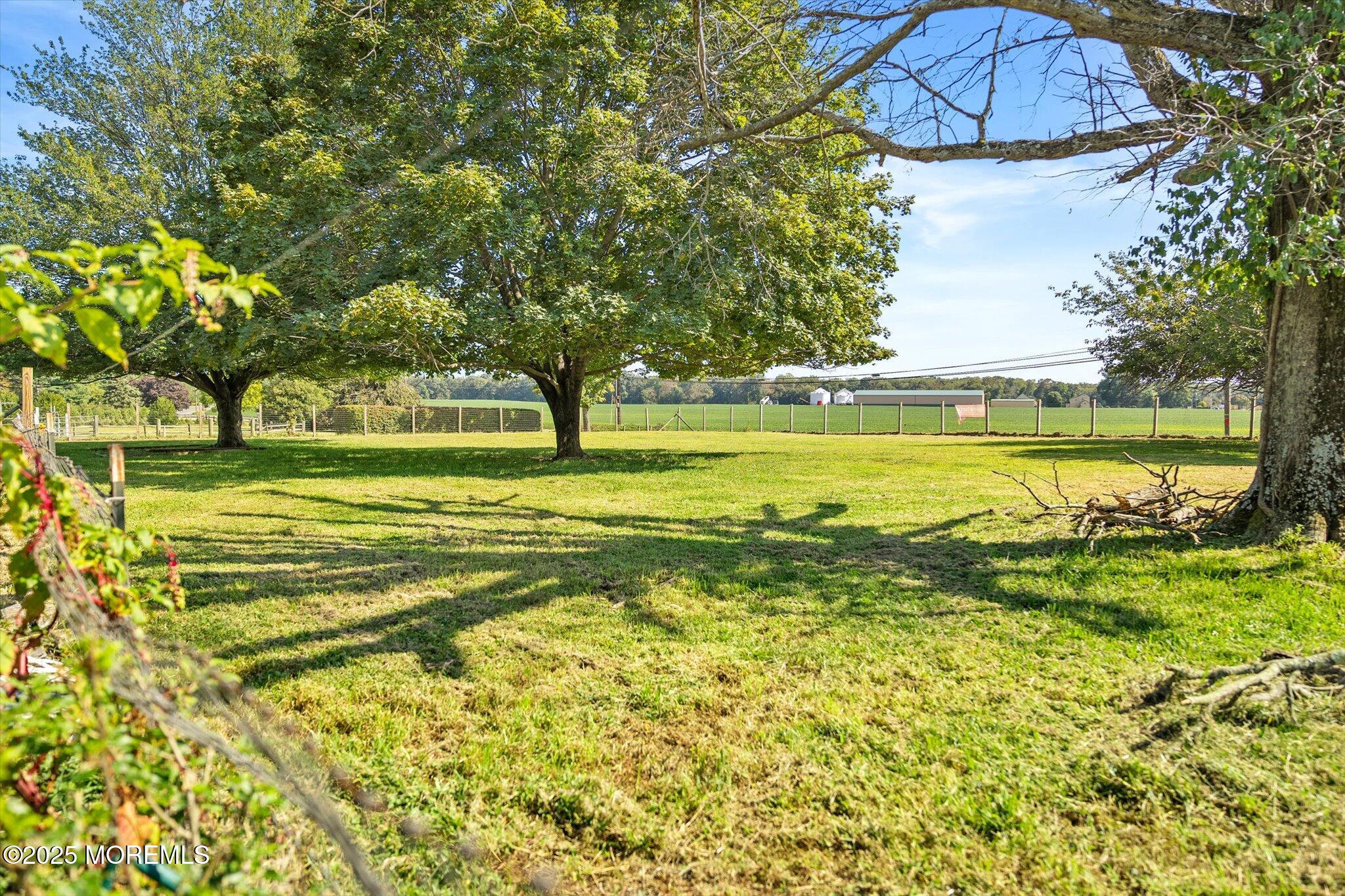 537 Chesterfield Arneytown Road Chesterfield, NJ 08515 - Photo 64 of 89 a view of a swimming pool with a lawn chairs under an umbrella