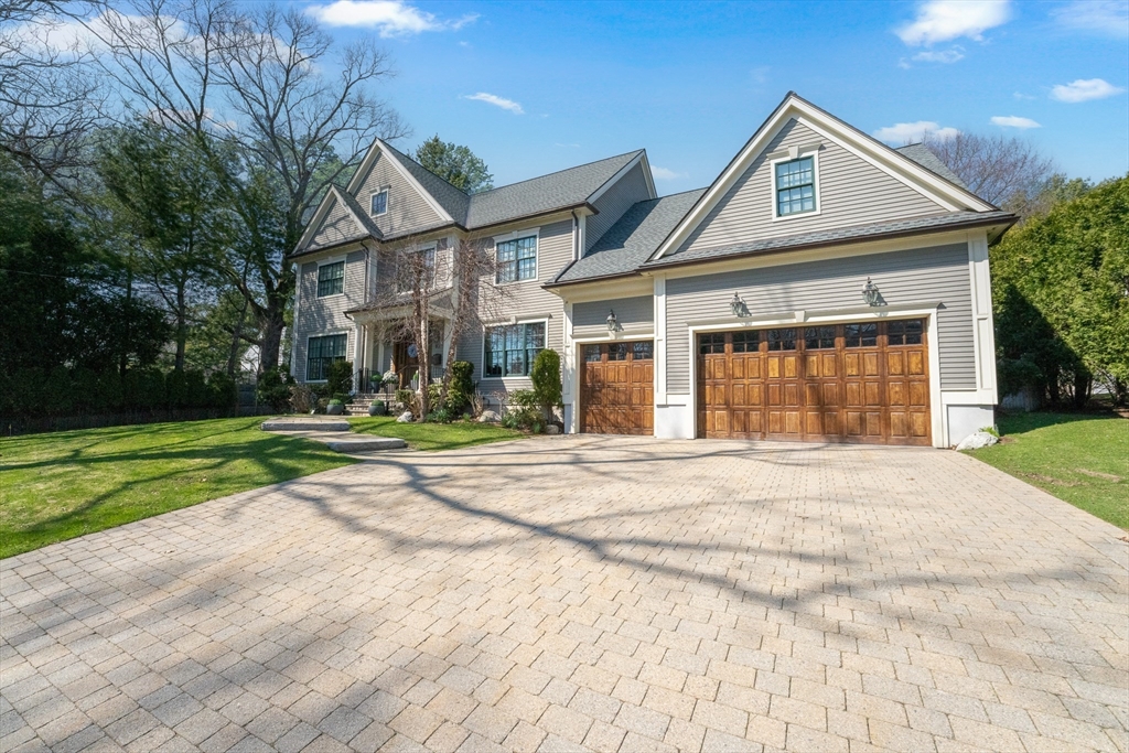 a front view of a house with a yard and garage