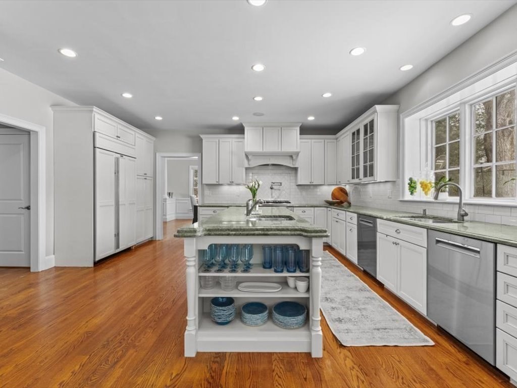81 Fuller Street Newton, MA 02465 - Photo 14 of 42 a kitchen with granite countertop wooden floors stainless steel appliances a sink and cabinets