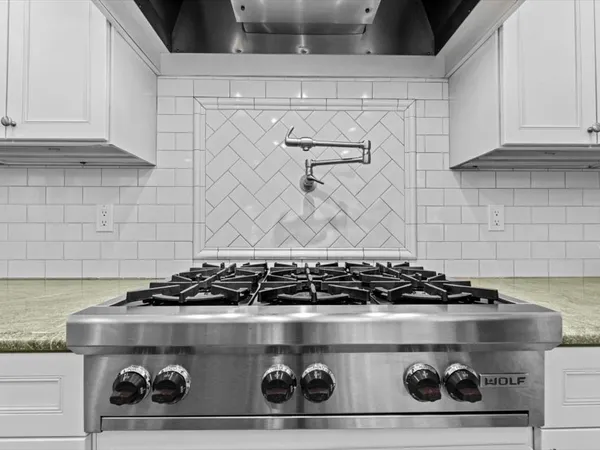 a bathroom with a granite countertop toilet sink and mirror