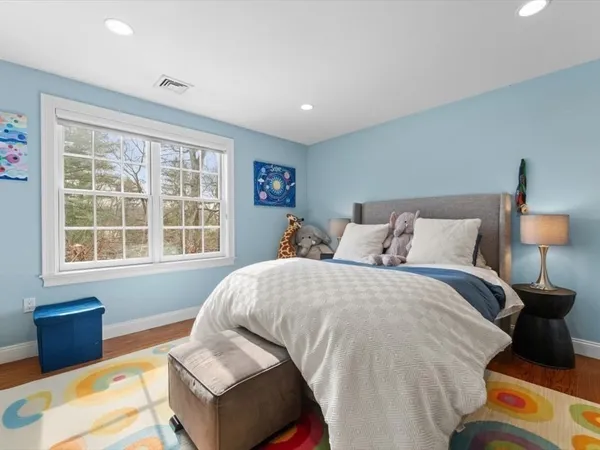 a bedroom with a large bed and a window