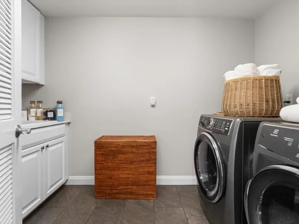 a bathroom with a granite countertop sink a toilet and a large mirror