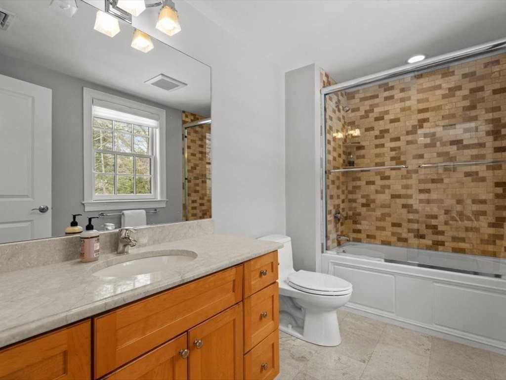 81 Fuller Street Newton, MA 02465 - Photo 29 of 42 a bathroom with a granite countertop sink a toilet and a large mirror