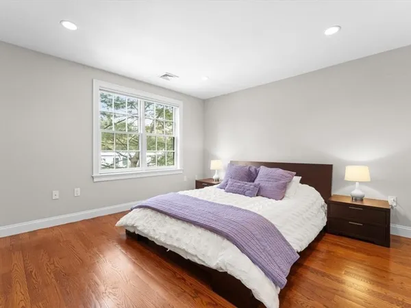 a bedroom with furniture and a flat screen tv