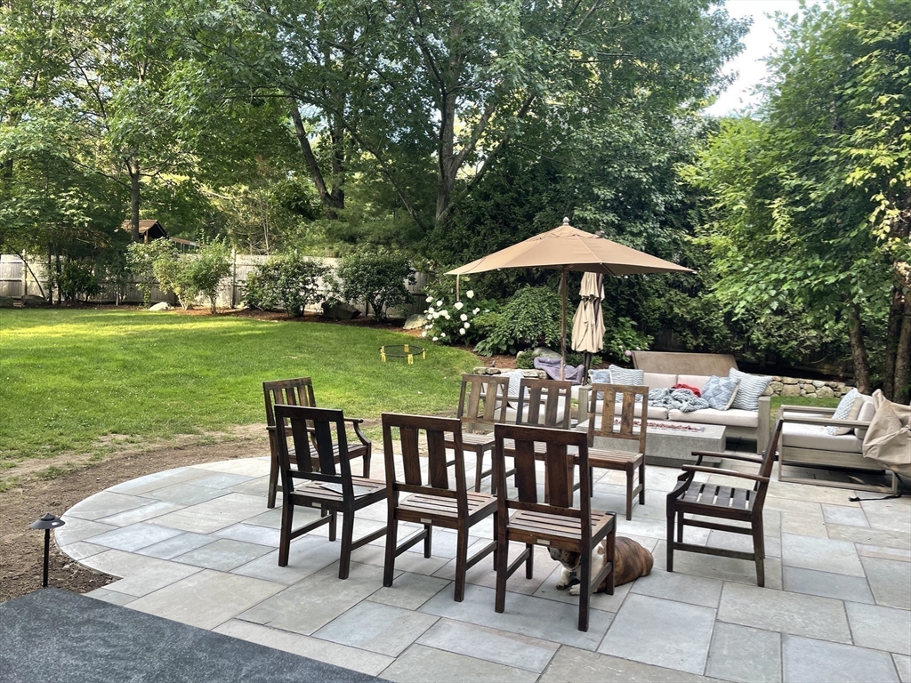 81 Fuller Street Newton, MA 02465 - Photo 40 of 42 a table and chairs with the view of trees in the background