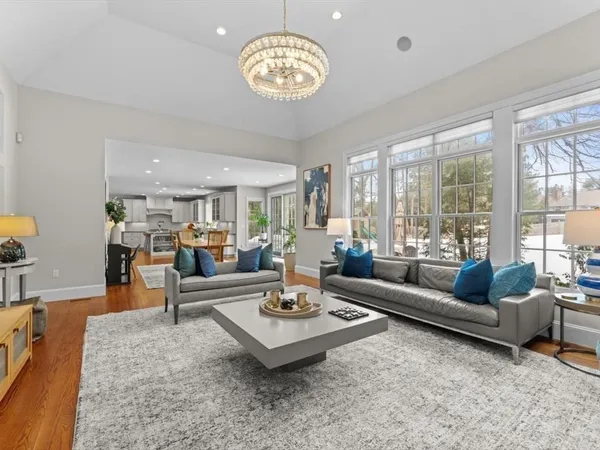 a living room with furniture a large window and a flat screen tv