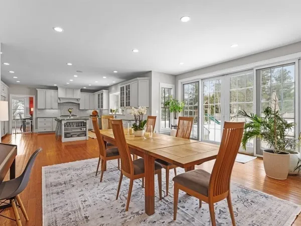 a kitchen with stainless steel appliances granite countertop wooden floors and white cabinets