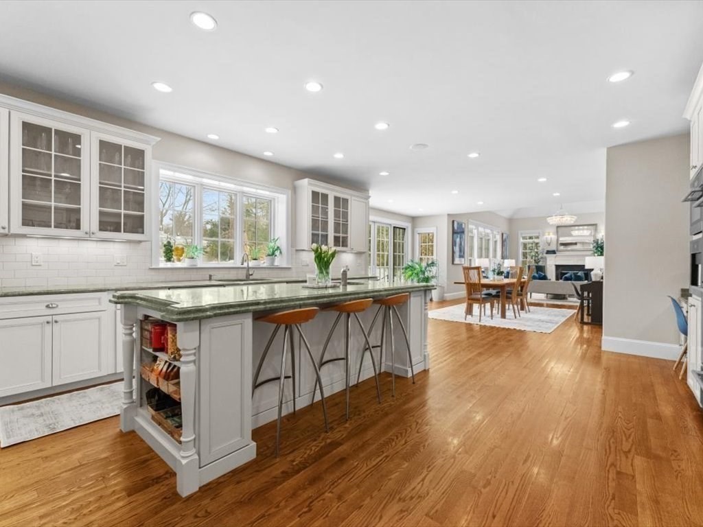81 Fuller Street Newton, MA 02465 - Photo 10 of 42 a kitchen with stainless steel appliances granite countertop wooden floors and white cabinets