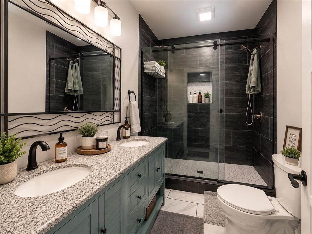 960 South Main Street Jasper, GA 30143 - Photo 6 of 12 a bathroom with a granite countertop sink toilet and shower