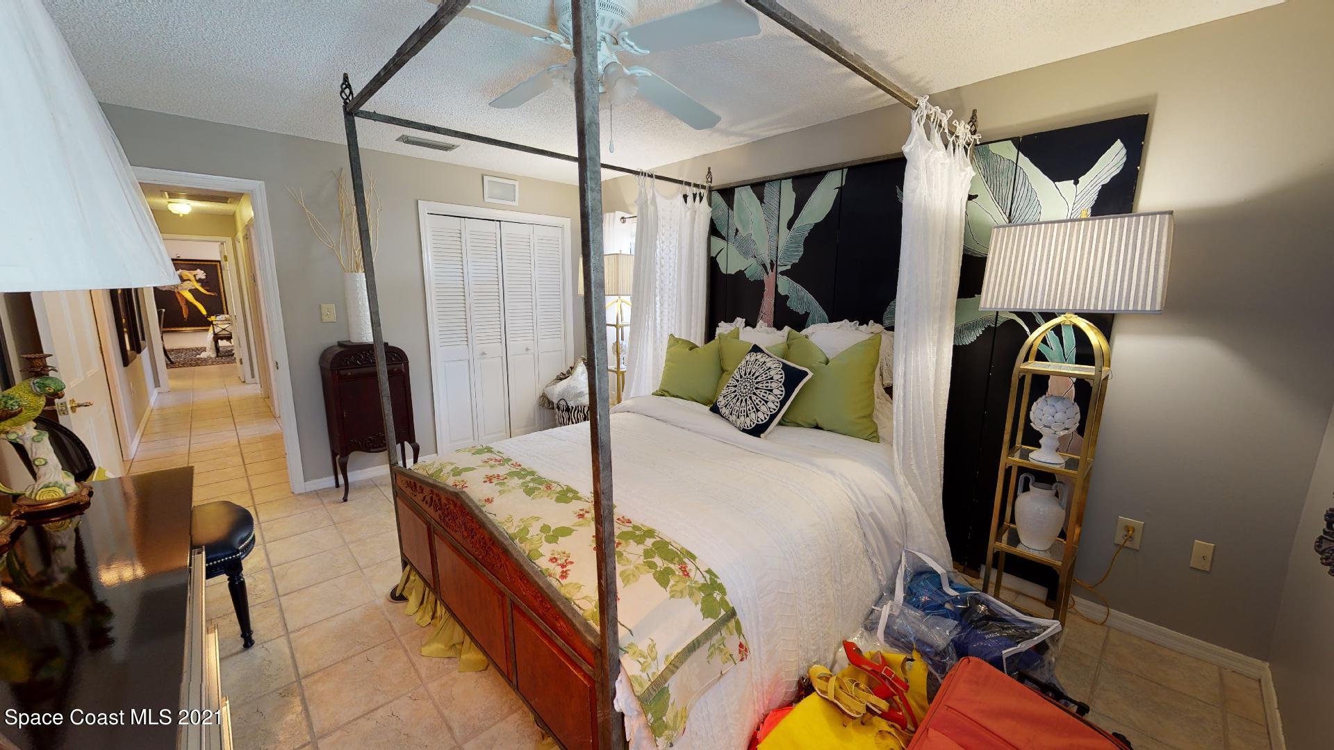 61 Country Club Road Cocoa Beach, FL 32931 - Photo 40 of 100 a bed room with a bed and a walk in closet