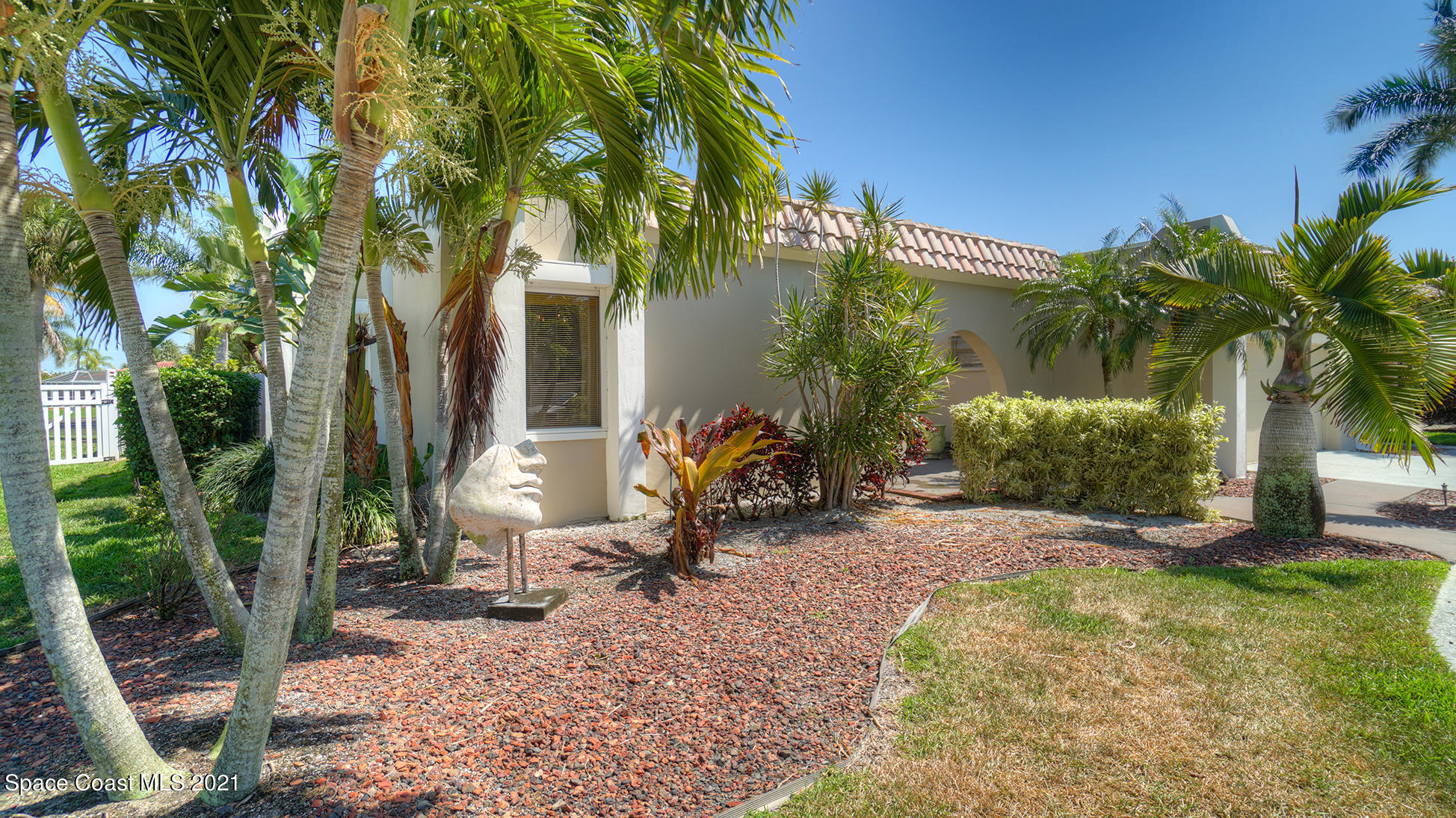 61 Country Club Road Cocoa Beach, FL 32931 - Photo 5 of 100 a front view of a house with garden