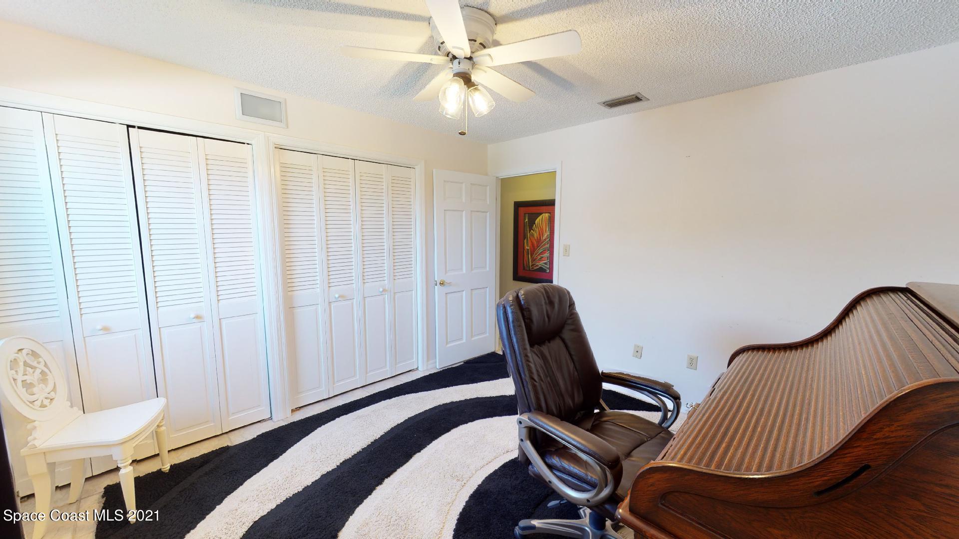 61 Country Club Road Cocoa Beach, FL 32931 - Photo 50 of 100 a view of a workspace with furniture and a window