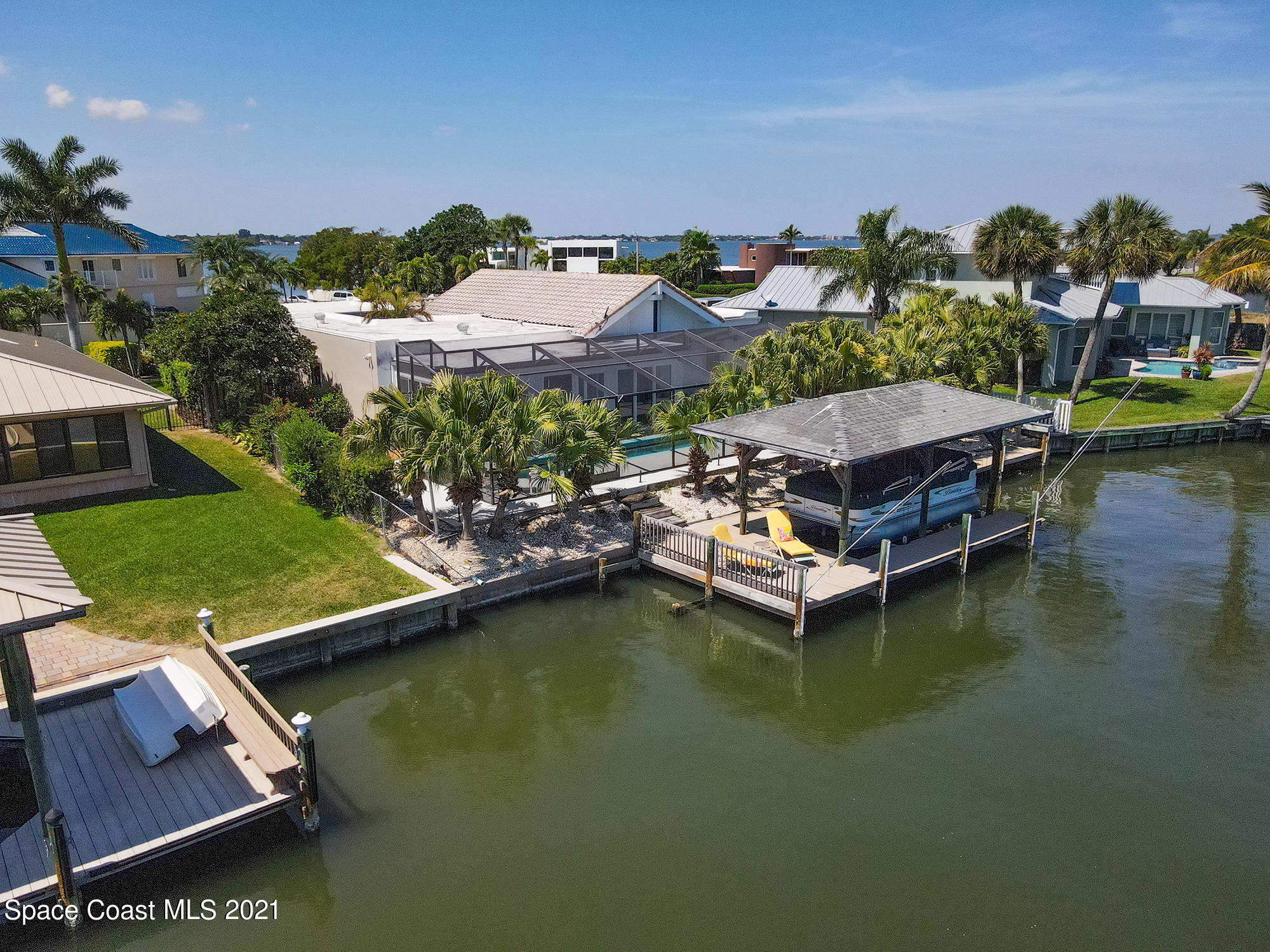 61 Country Club Road Cocoa Beach, FL 32931 - Photo 80 of 100 an aerial view of a house with a garden and lake view