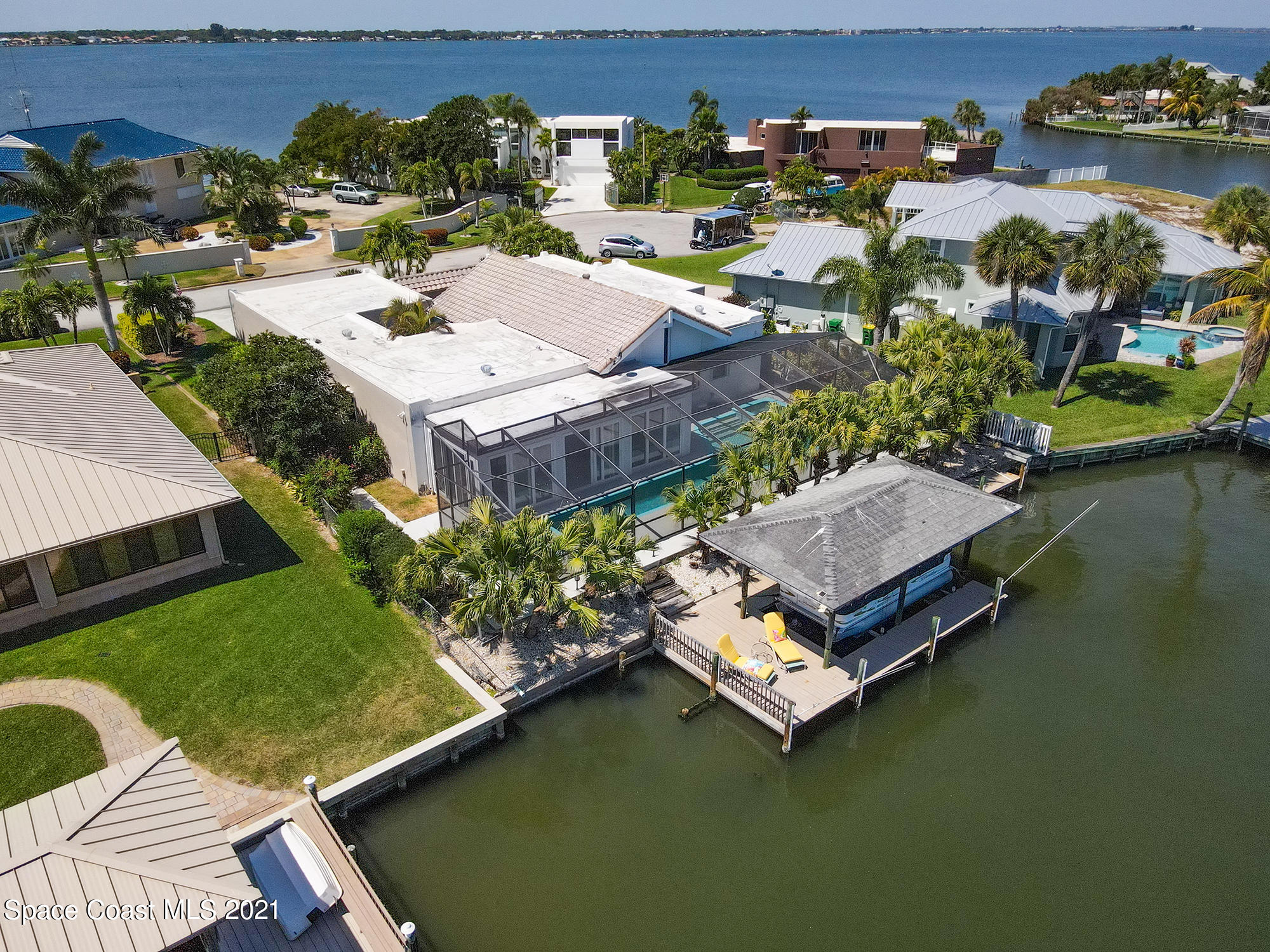 61 Country Club Road Cocoa Beach, FL 32931 - Photo 81 of 100 a aerial view of a house with a garden and lake view