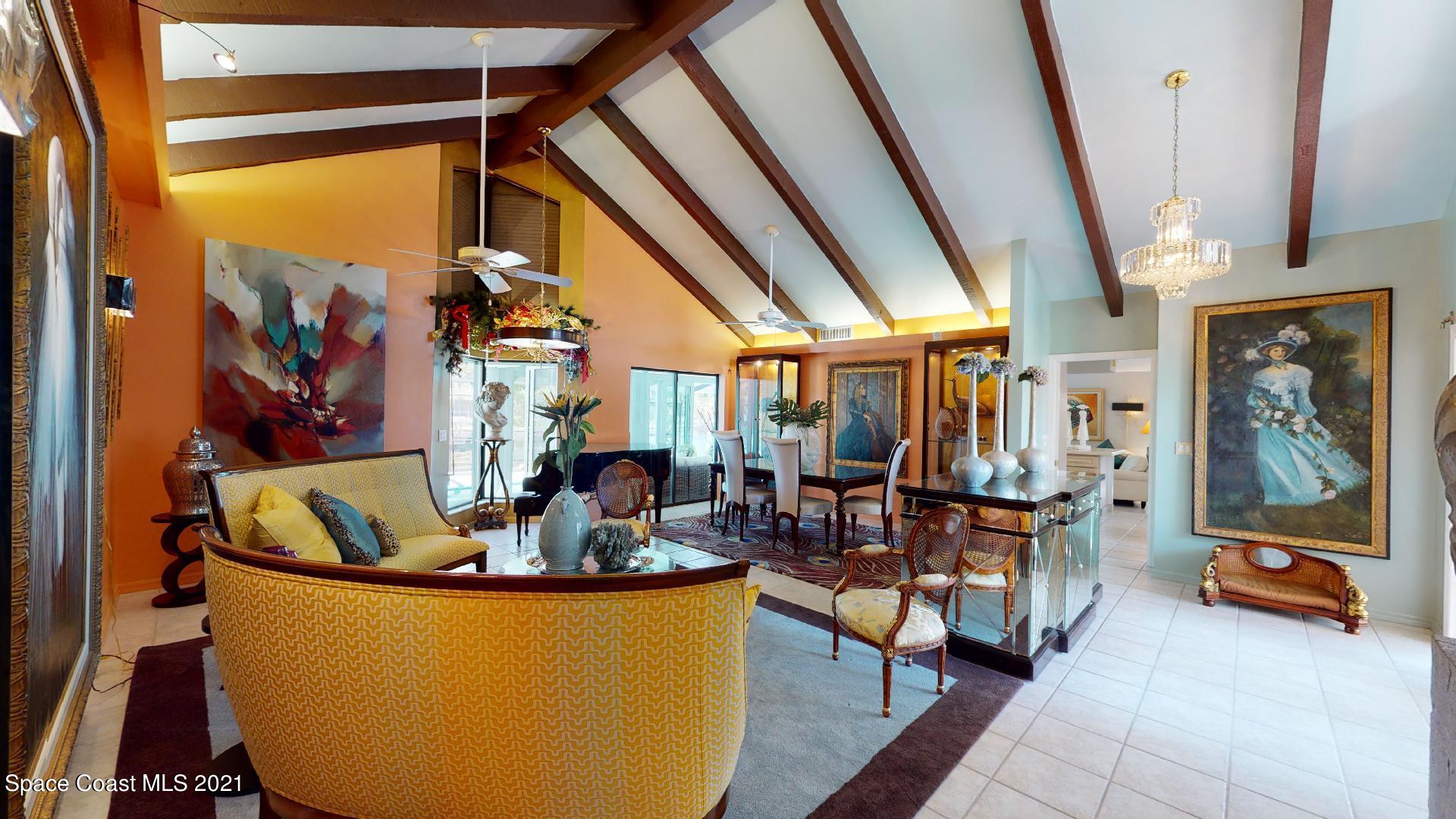 61 Country Club Road Cocoa Beach, FL 32931 - Photo 10 of 100 a living room with furniture and a floor to ceiling window