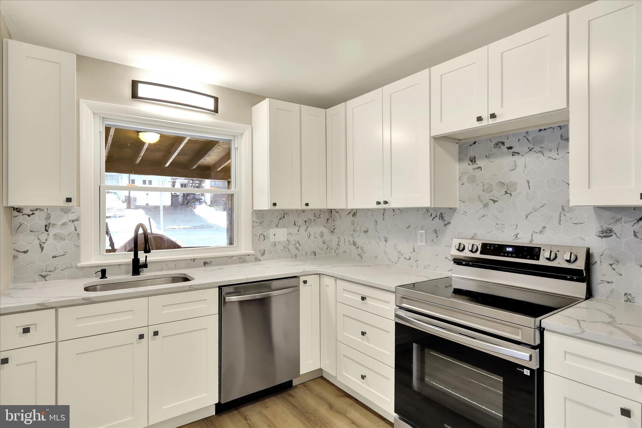 2560 Grant Street Reading, PA 19606 - Photo 13 of 30 a kitchen with granite countertop white cabinets and white appliances