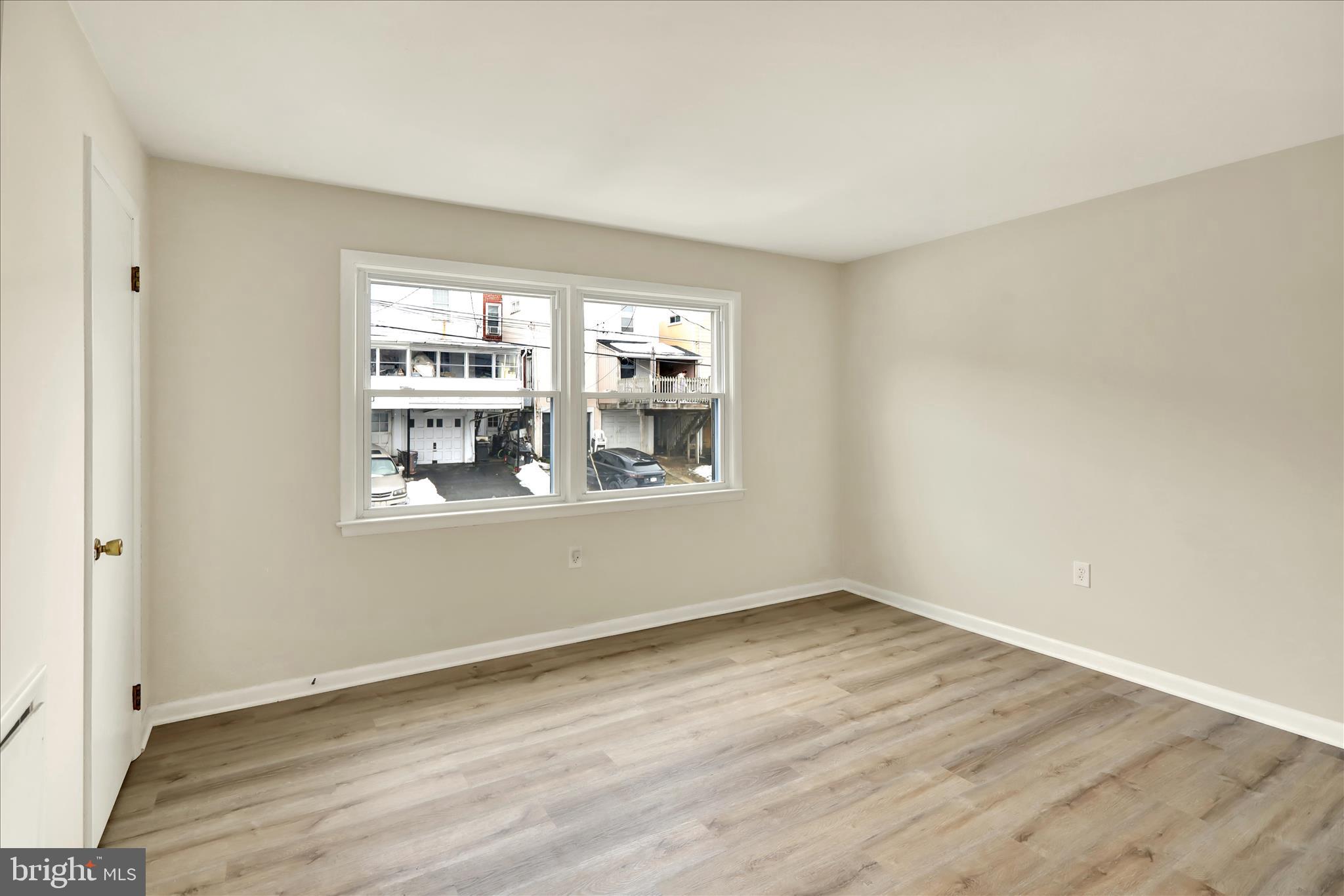 2560 Grant Street Reading, PA 19606 - Photo 14 of 30 a view of an empty room with wooden floor and a window