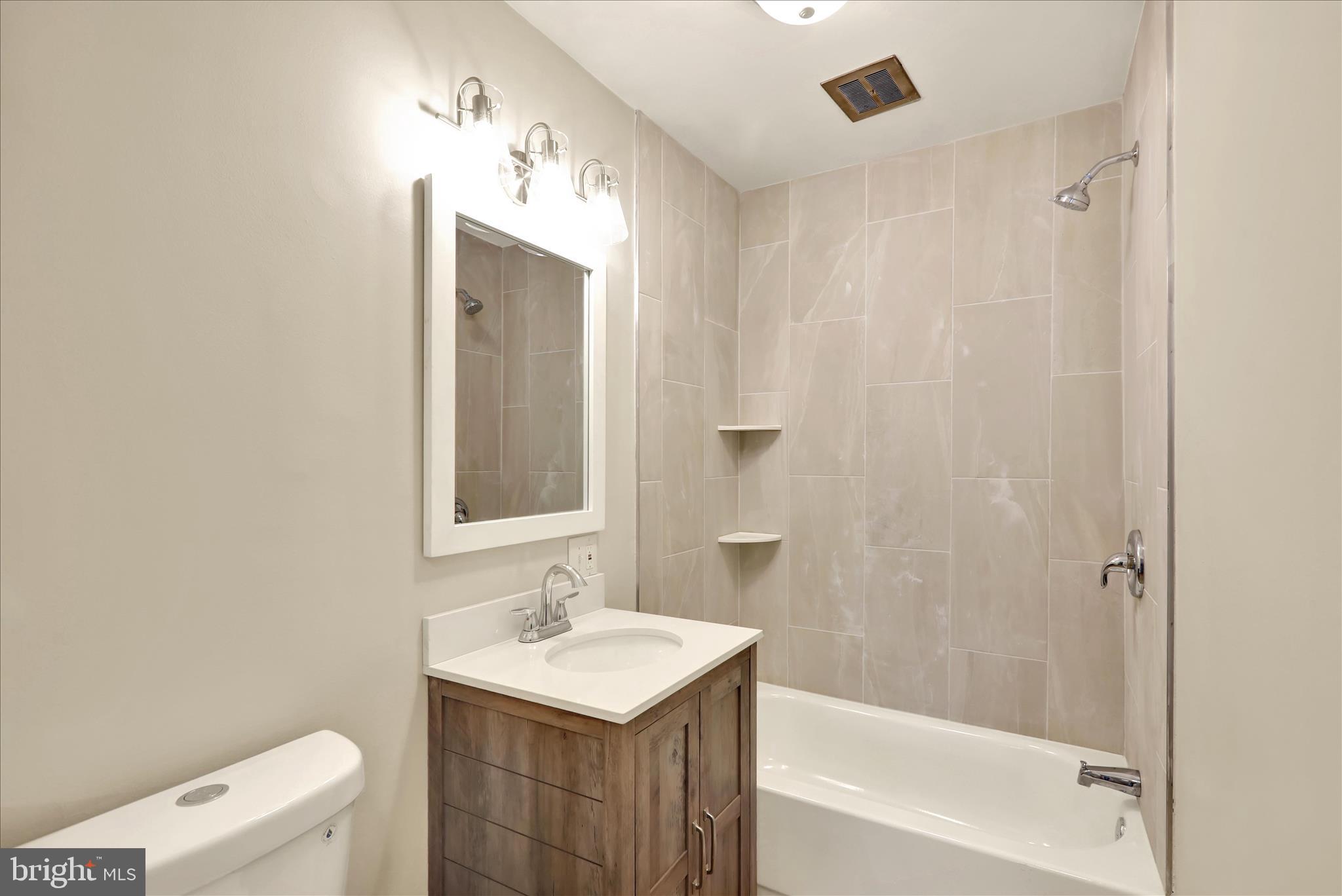 2560 Grant Street Reading, PA 19606 - Photo 16 of 30 a bathroom with a sink a toilet and shower