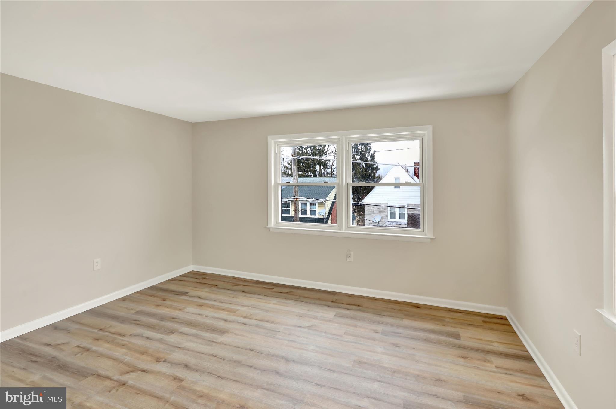 2560 Grant Street Reading, PA 19606 - Photo 20 of 30 a view of an empty room with wooden floor and a window