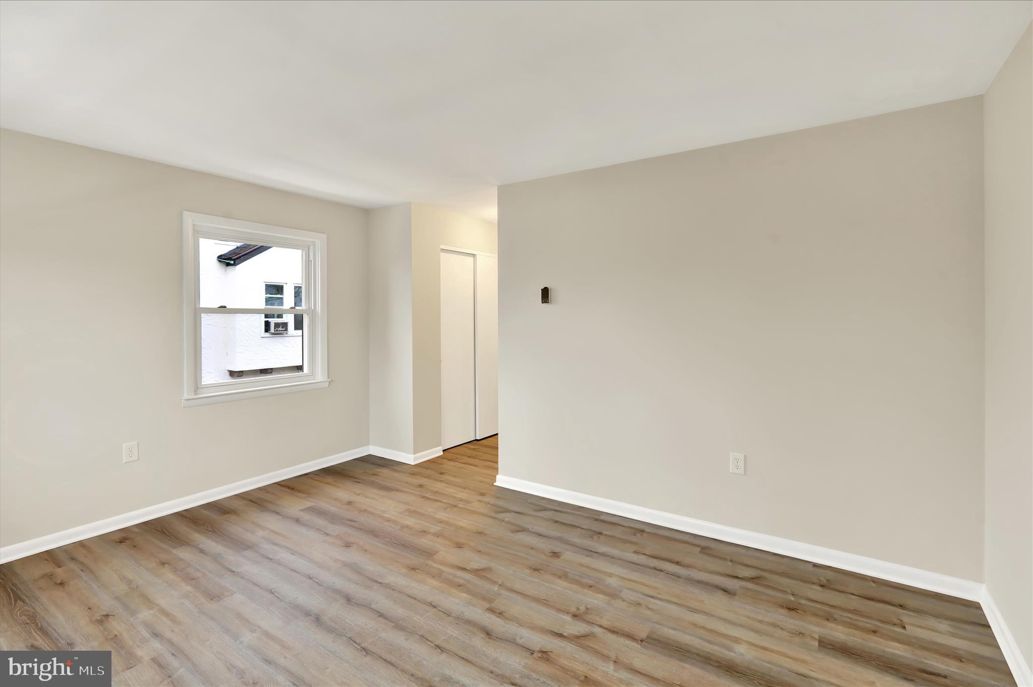 2560 Grant Street Reading, PA 19606 - Photo 21 of 30 a view of an empty room with wooden floor and a window