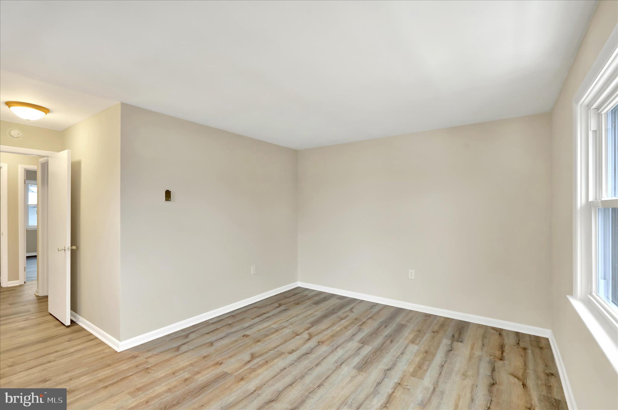 2560 Grant Street Reading, PA 19606 - Photo 22 of 30 an empty room with wooden floor and windows