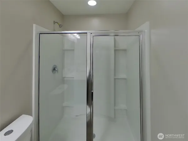 a bathroom with a glass shower door