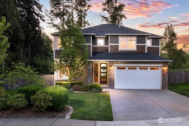 11 200th Place Southwest Bothell, WA 98012 - Photo 1 of 40 a front view of a house with a garden and garage