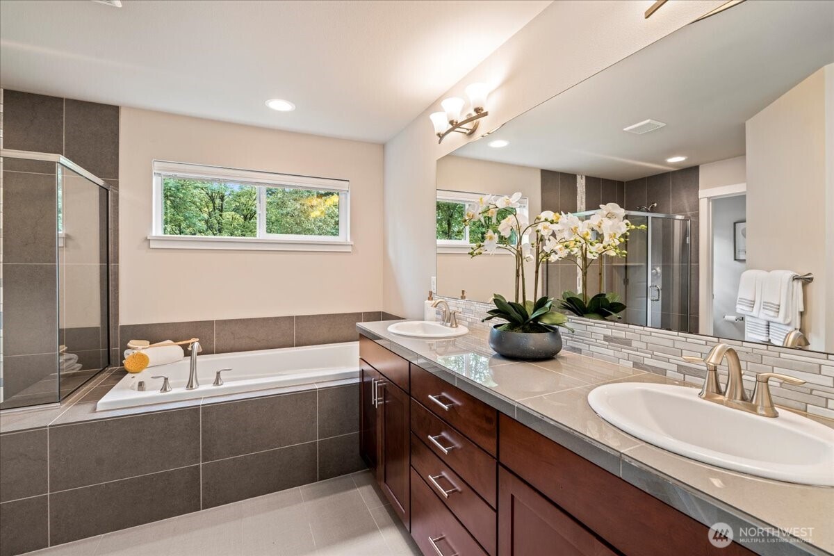 11 200th Place Southwest Bothell, WA 98012 - Photo 26 of 40 a bathroom with a granite countertop sink and a large mirror