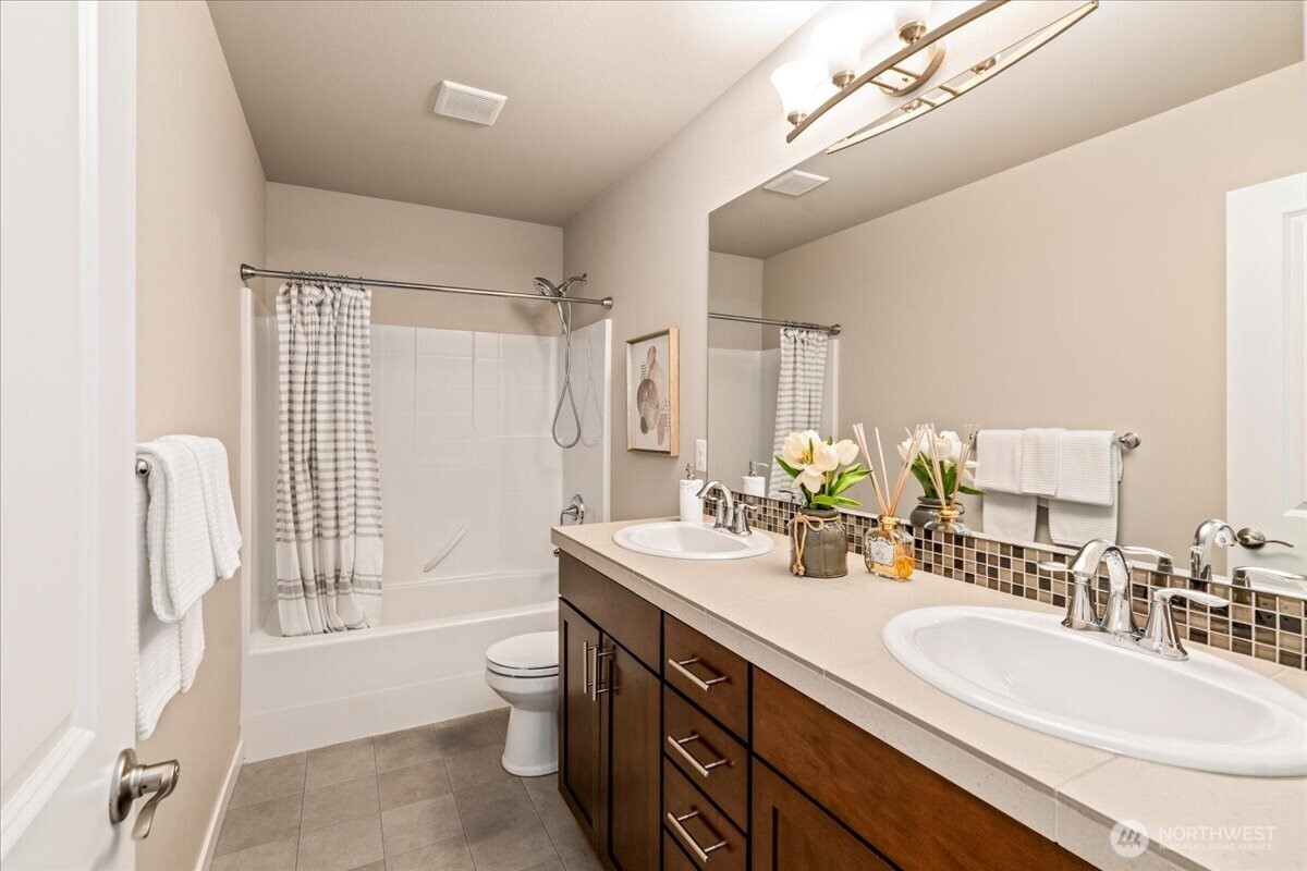 11 200th Place Southwest Bothell, WA 98012 - Photo 35 of 40 a bathroom with a double vanity sink toilet mirror and shower