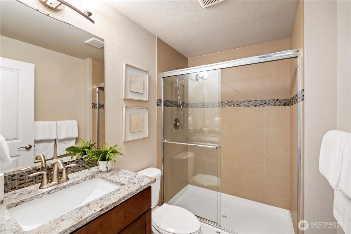 11 200th Place Southwest Bothell, WA 98012 - Photo 6 of 40 a bathroom with a granite countertop sink toilet and shower