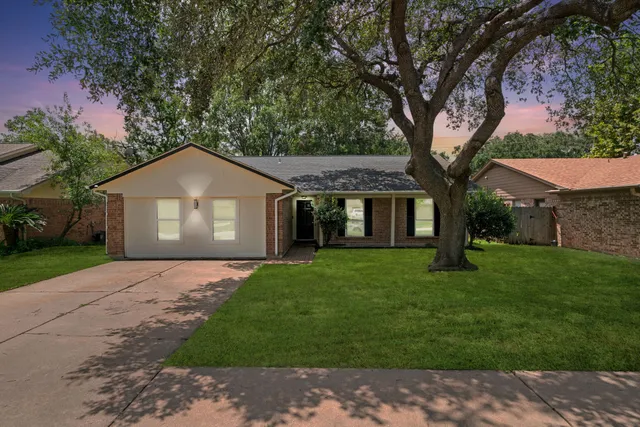 a house that is sitting in middle od the grass