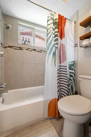 a bathroom with a sink a toilet and bathtub