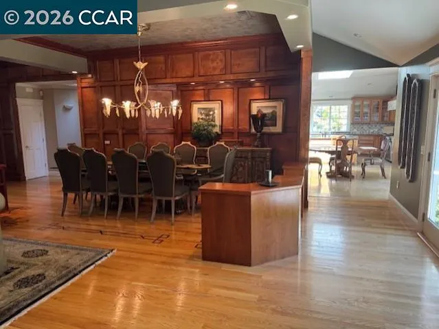 a living room with lots of furniture and chandelier