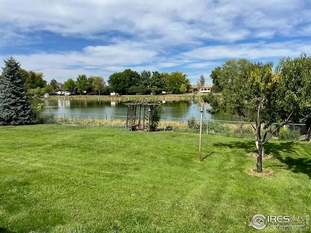 a view of a lake with houses in the back