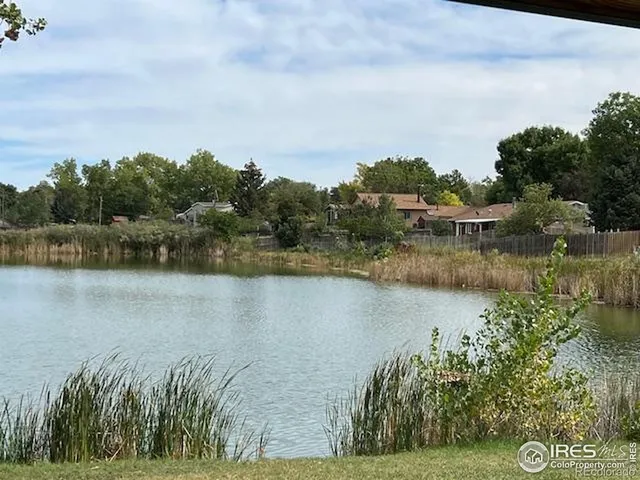 a view of a lake with houses in the back