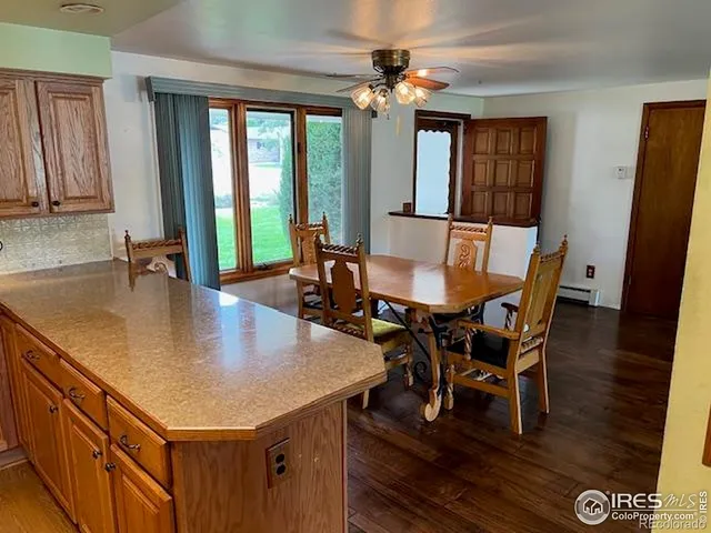 a dining room with furniture a chandelier and wooden floor