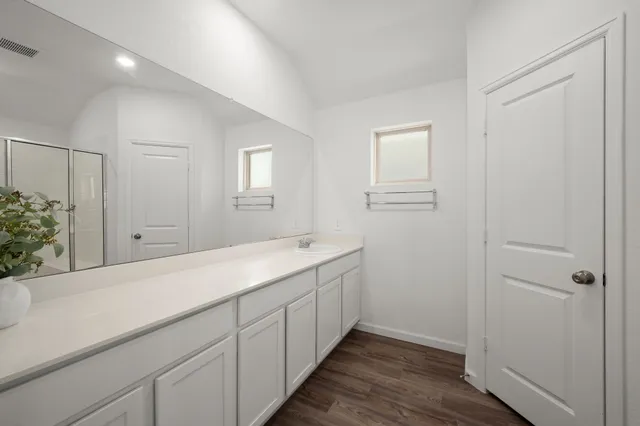 a bathroom with a sink and mirror