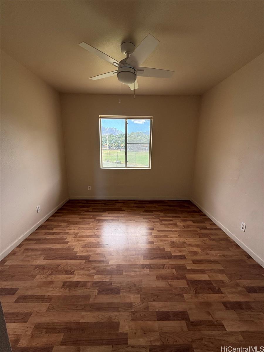 85-808 Lihue Street, Unit UPPR Waianae, HI 96792 - Photo 12 of 19 an empty room with wooden floor and windows