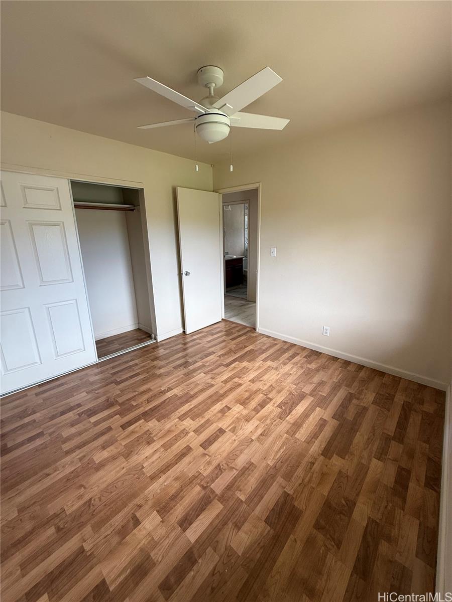 85-808 Lihue Street, Unit UPPR Waianae, HI 96792 - Photo 14 of 19 an empty room with wooden floor and fan