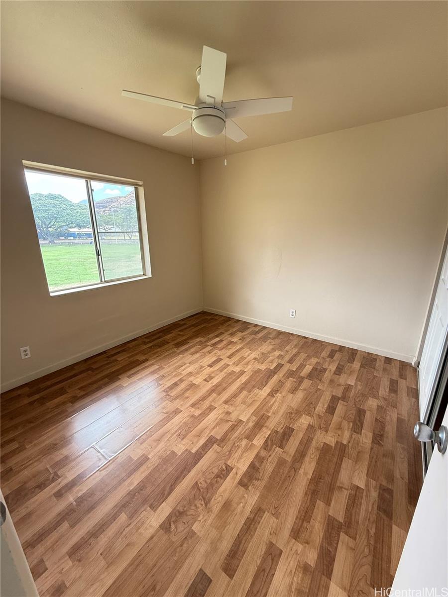 85-808 Lihue Street, Unit UPPR Waianae, HI 96792 - Photo 15 of 19 an empty room with wooden floor and windows