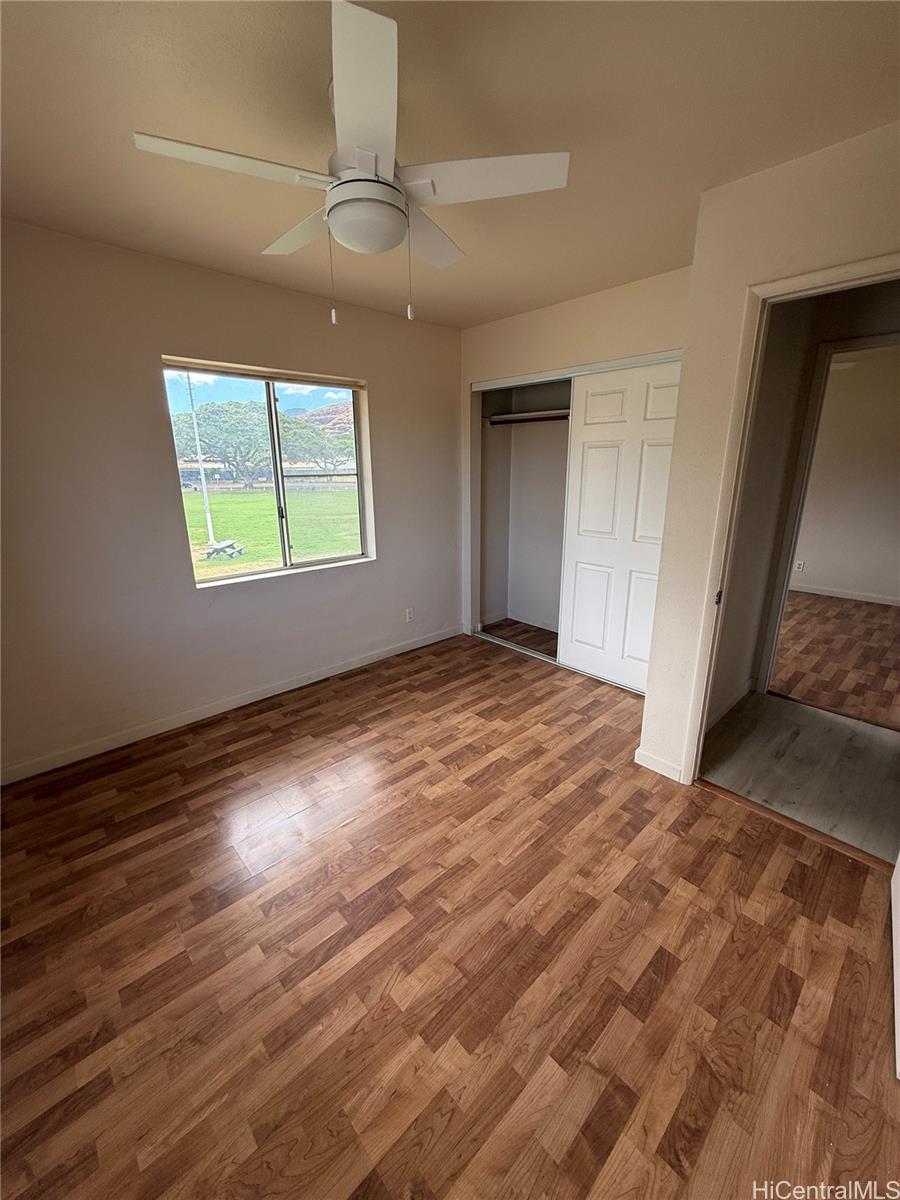 85-808 Lihue Street, Unit UPPR Waianae, HI 96792 - Photo 17 of 19 a view of empty room with wooden floor and fan