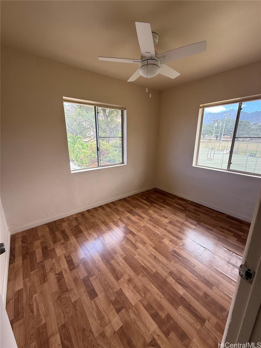 85-808 Lihue Street, Unit UPPR Waianae, HI 96792 - Photo 18 of 19 a view of an empty room with wooden floor and a window