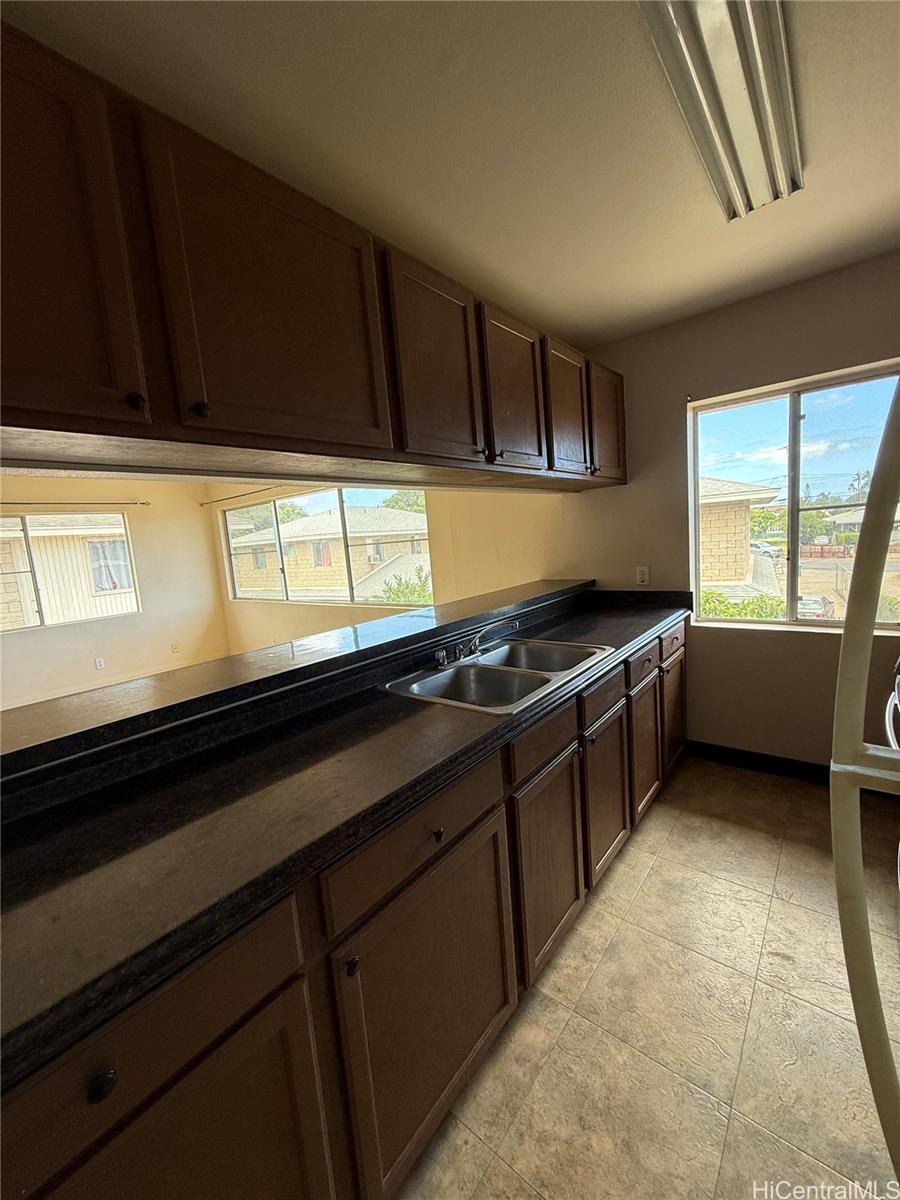 85-808 Lihue Street, Unit UPPR Waianae, HI 96792 - Photo 7 of 19 a kitchen with stainless steel appliances a sink stove and cabinets