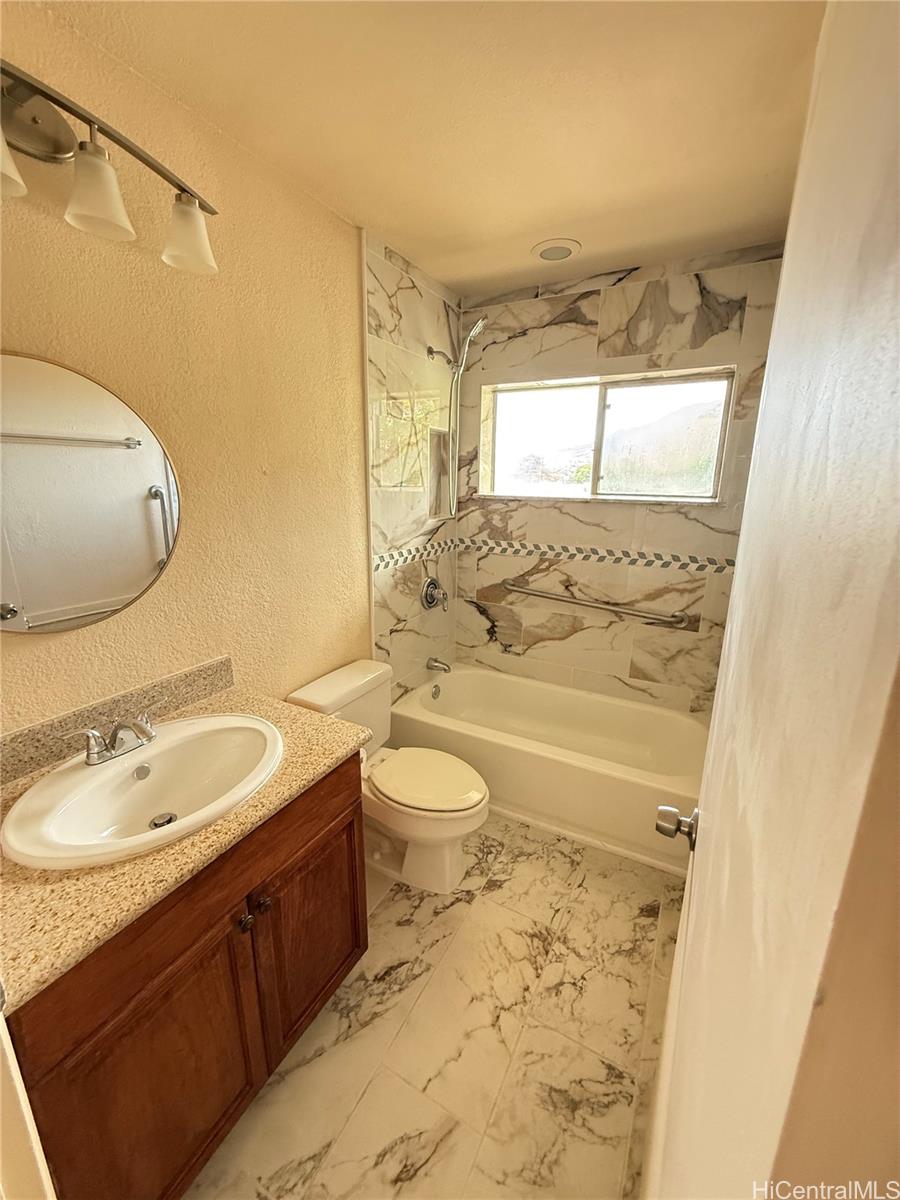85-808 Lihue Street, Unit UPPR Waianae, HI 96792 - Photo 8 of 19 a bathroom with a sink toilet granite tub and shower