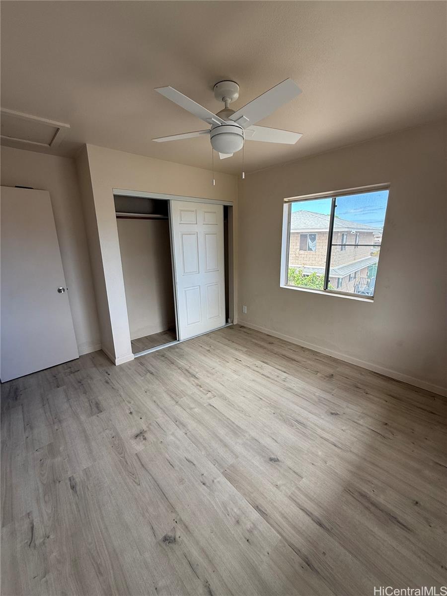 85-808 Lihue Street, Unit UPPR Waianae, HI 96792 - Photo 10 of 19 an empty room with wooden floor fan and windows