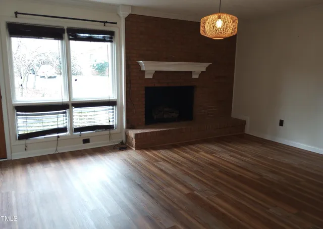 a view of a room with wooden floor and chandelier