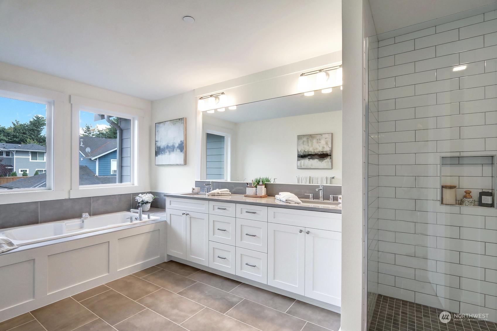 7922 203rd Street Southwest Edmonds, WA 98026 - Photo 19 of 33 a large bathroom with a double vanity sink a large mirror and a bathtub