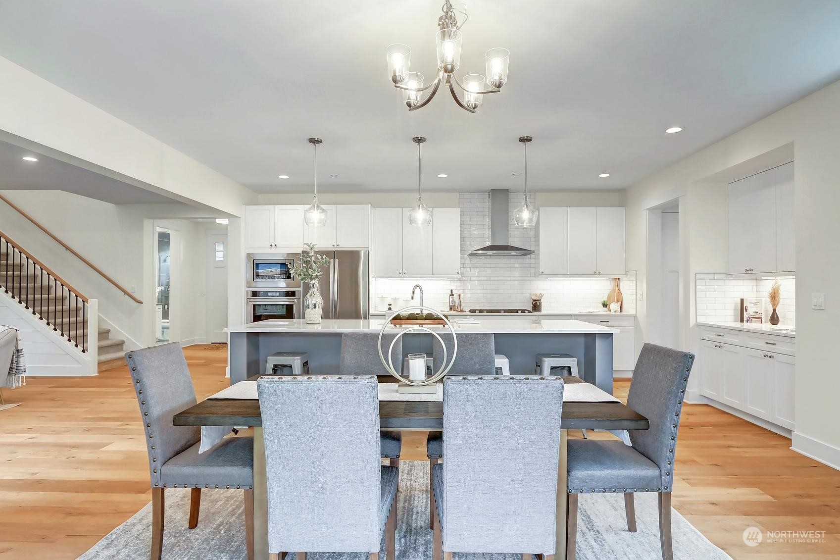 7922 203rd Street Southwest Edmonds, WA 98026 - Photo 8 of 33 a kitchen with stainless steel appliances granite countertop a kitchen island and chairs in it