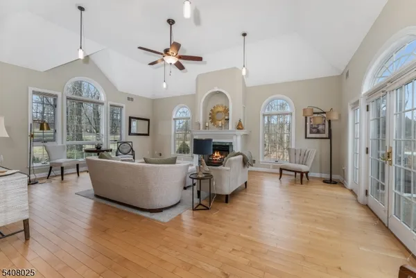 a living room with furniture a fireplace and a chandelier