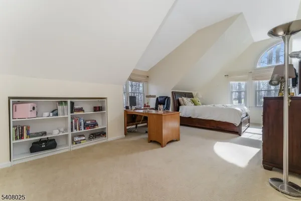 a bedroom with furniture and a book shelf